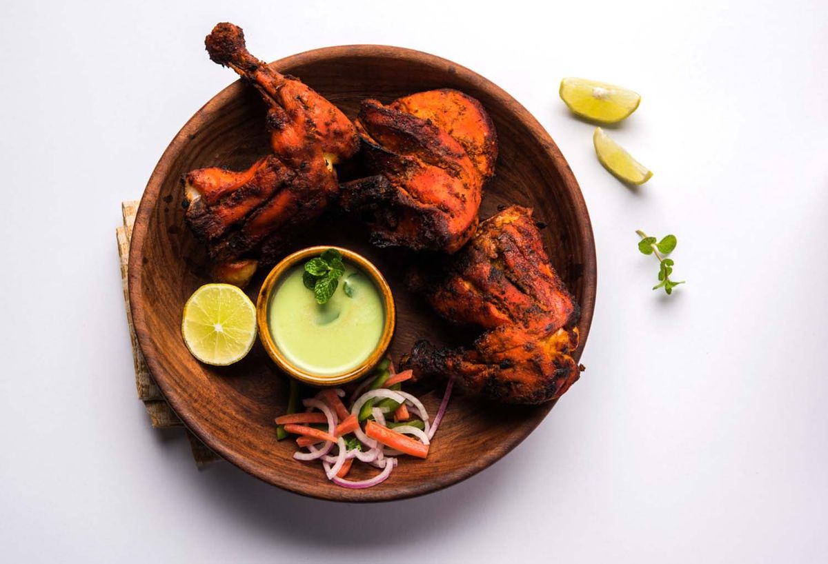 Tandoori chicken grilled in a clay oven, featured in a blog about authentic Indian flavors in Los Angeles.