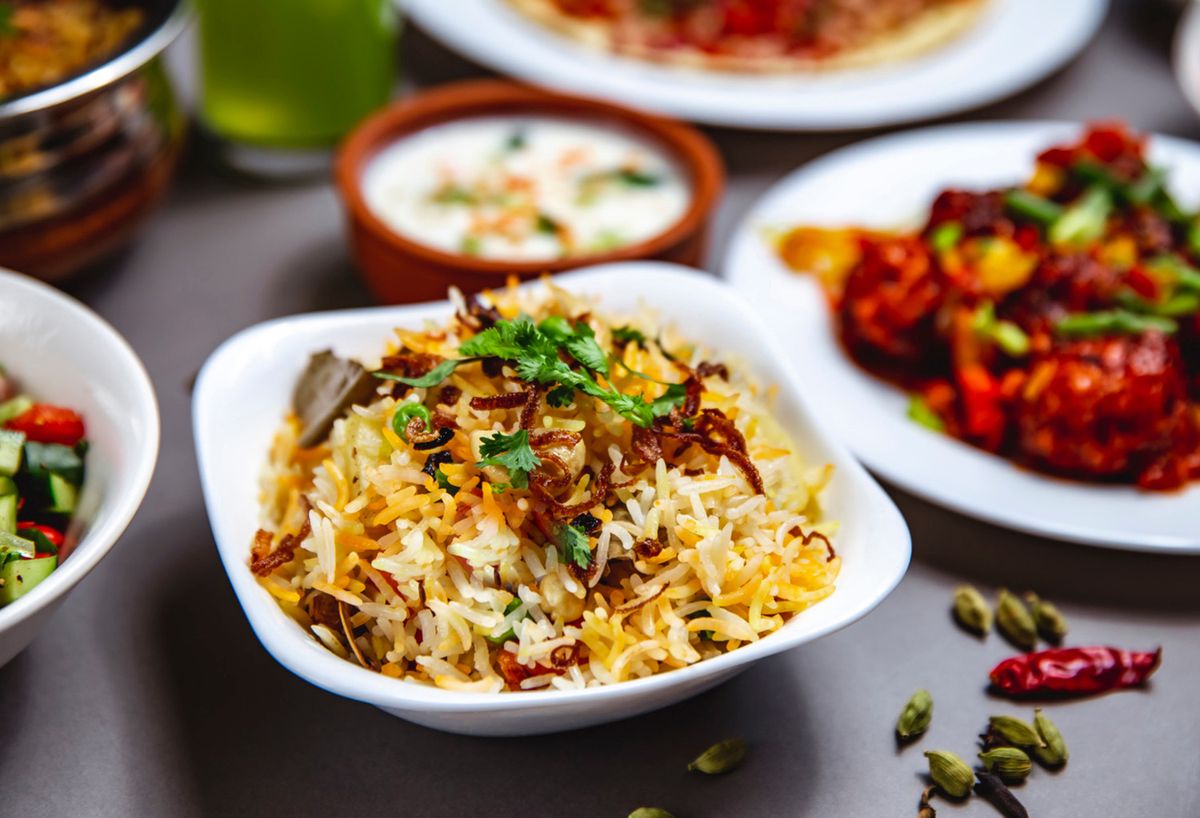 Vegetable biryani served with spices and herbs, highlighted in a blog for vegetarian Indian dishes.