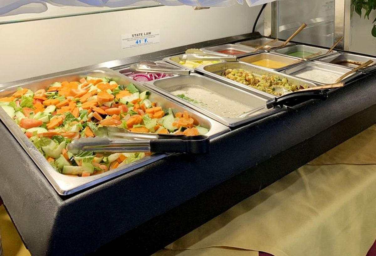 Indian buffet spread with multiple dishes, promoting all-you-can-eat lunch in Hawthorne.