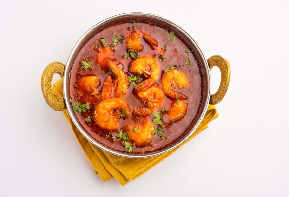 Shrimp masala dish with rich sauce, showcasing Indian seafood specialties.