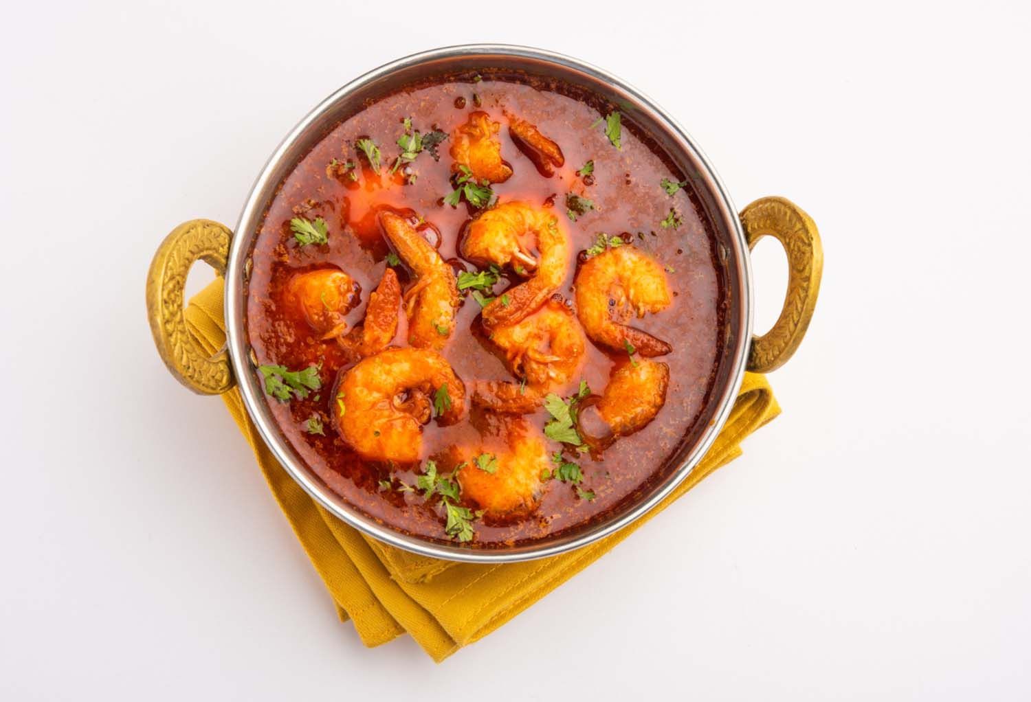 Shrimp masala dish with rich sauce, showcasing Indian seafood specialties.