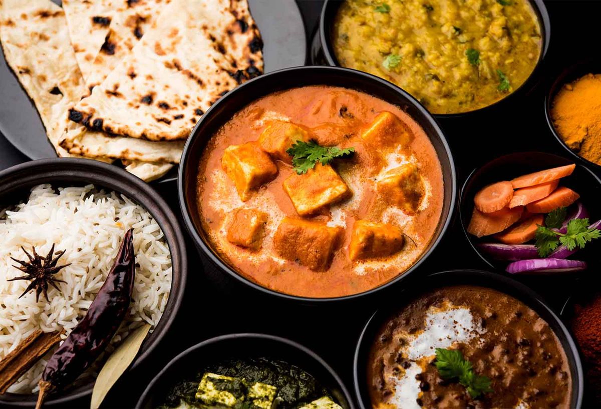 Traditional Indian dishes including curry and naan, representing authentic cuisine in Hawthorne.
