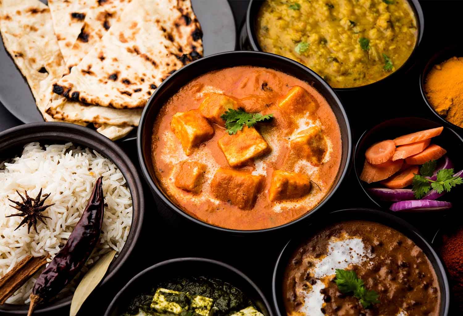 Traditional Indian dishes including curry and naan, representing authentic cuisine in Hawthorne.