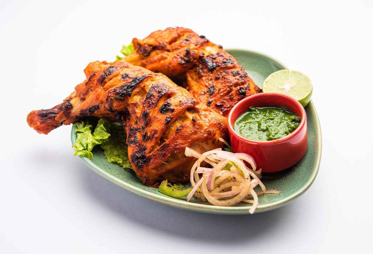 Tandoori chicken served with spices, featured in a blog about its popularity in Hawthorne.