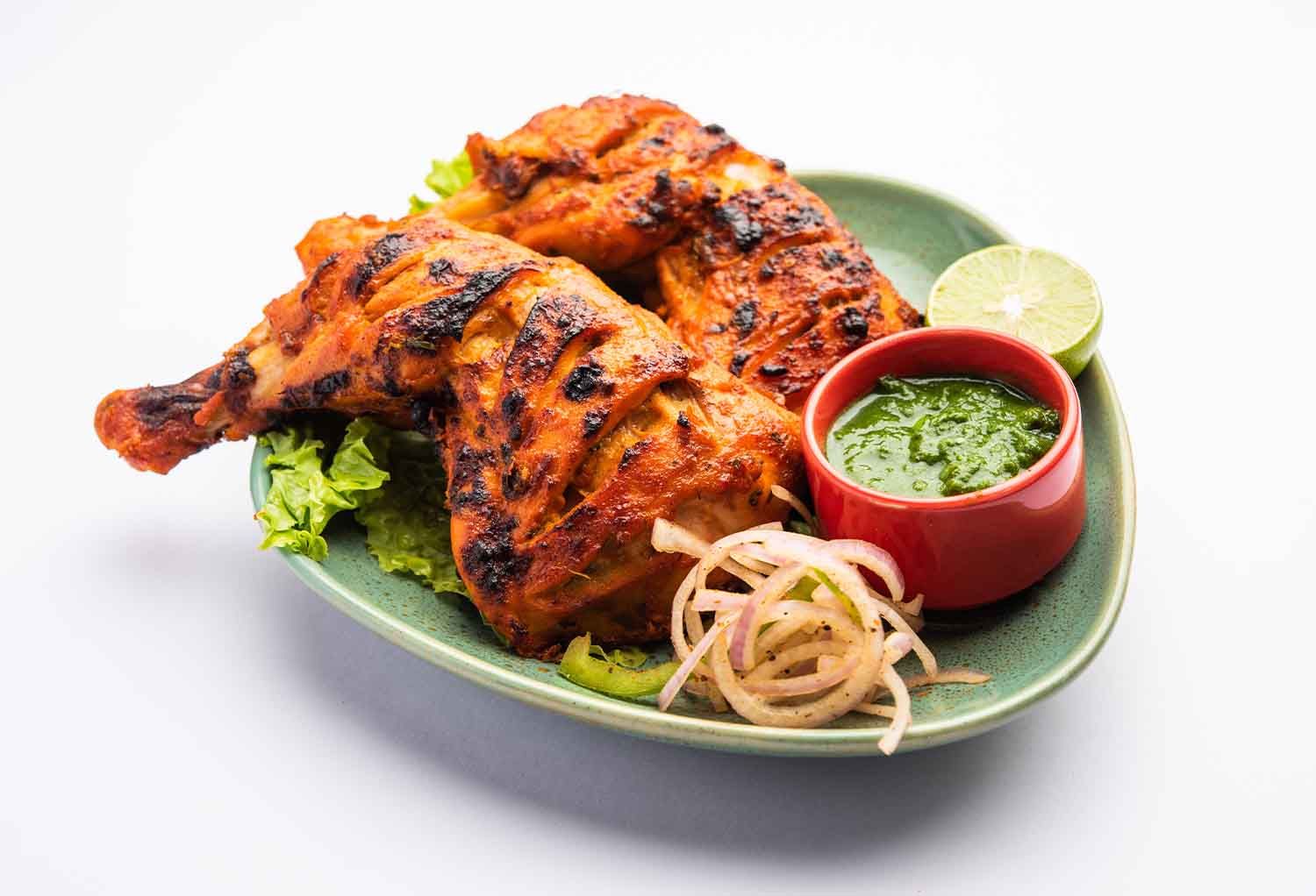 Tandoori chicken served with spices, featured in a blog about its popularity in Hawthorne.