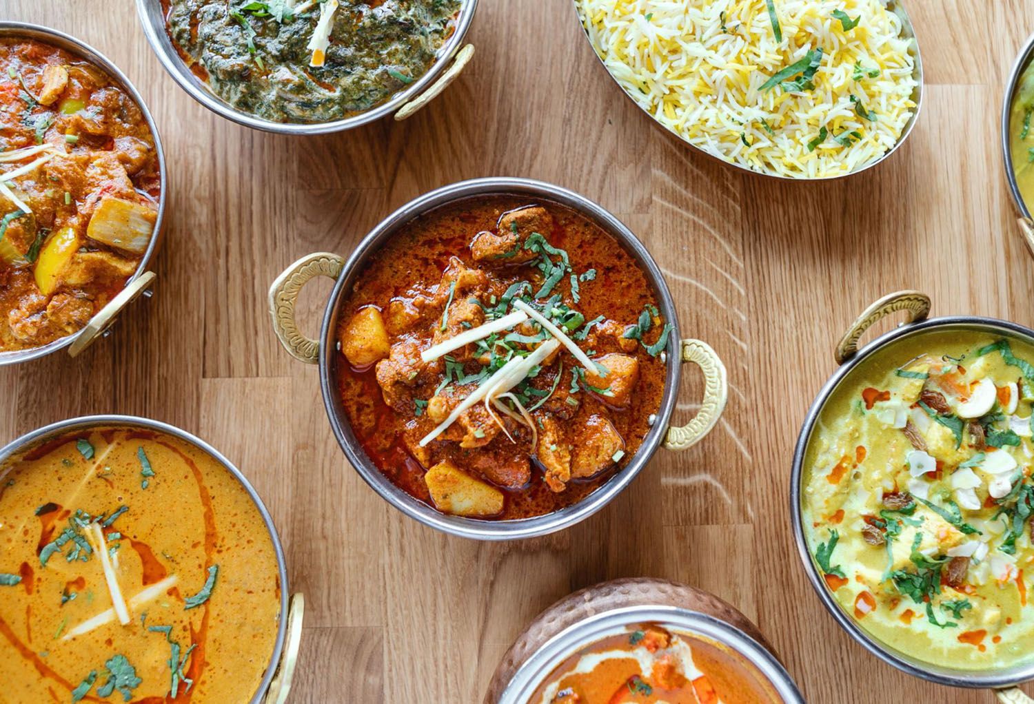 Variety of Indian dishes with chicken curry, paneer curry and rice